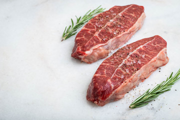 Raw fresh meat Top Blade steaks on light background. with copy space