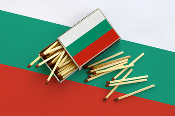 Bulgaria flag  is shown on an open matchbox, from which several matches fall and lies on a large...