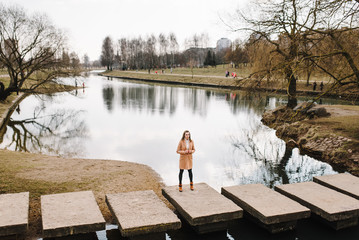 beautiful girl in a coat outdoors. portrait of a young woman outdoors