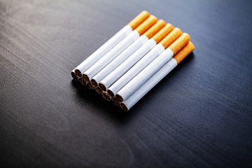 Stop smoking concept on background with broken cigarettes. Heap of cigarettes. No smoking