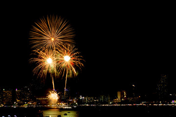 Fototapeta premium Many flashing fireworks with night cityscape background celebrate New Year.