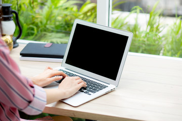 Beautiful of portrait asian young woman working online on laptop computer sitting at coffee shop, professional female freelancer using notebook with connect to internet for distance job.