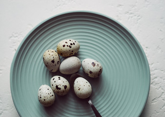 small fresh raw quail eggs in a plate top view