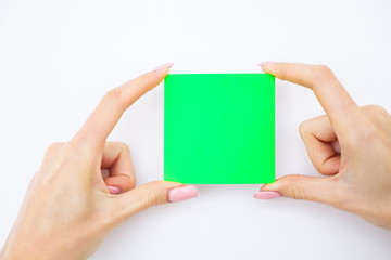 Blank Folder with Green Paper. Hand that Holding Folder and Pan Handle on White Background. Copyspace. Place for Text