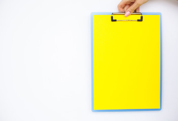 Blank Folder with Yellow Paper. Hand that Holding Folder and Handle on White Background. Copyspace. Place for Text.