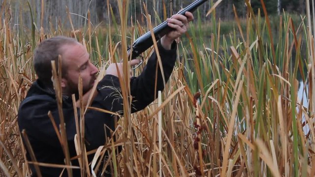 Hunter aims at the sky pulls back the hammer and pulls the trigger, quick action as if he saw a flying duck.