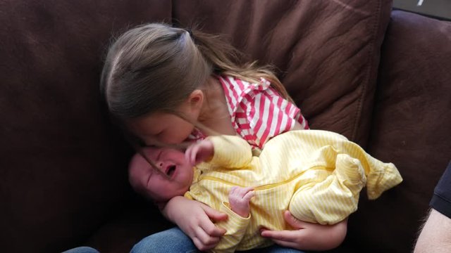 Big sister with newborn baby.