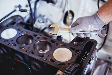 auto mechanic working on a car engine