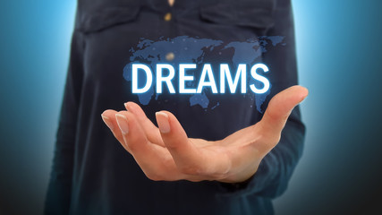 Business woman holding dreams over world map hologram