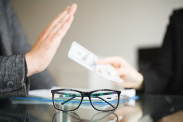 Businessman refusing or rejecting money in the envelope - anti bribery and corruption concepts