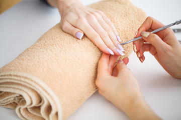 SPA manicure. French manicure at spa salon. Woman hands in a nail salon receiving a manicure...