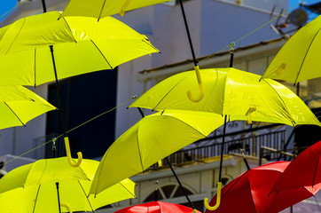 Colourful umbrellas urban street decoration. Hanging colorful umbrellas over blue sky, tourist attraction