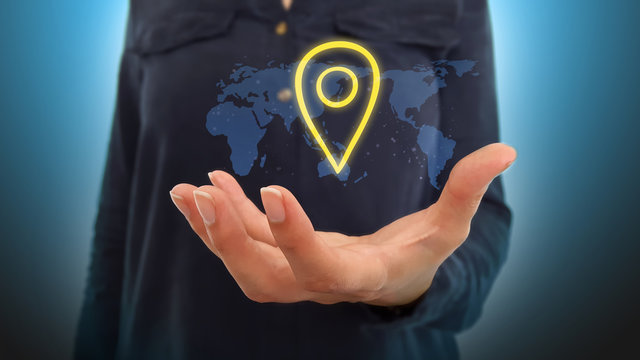 Businesswoman on blurred background holding hand localisation map over world map hologram
