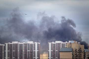 Fire. Black smoke over the building. City fire. Smoke from a fire.