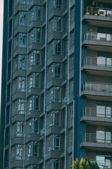 Bottom view of modern skyscrapers in business district against blue sky.