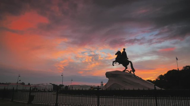 Saint-Petersburg, Russia, old The Bronze Horseman monument installed at year 1768, in the Senate Square, is a symbol of the city, timelapse 4k shot, beautiful sunrise with colorful clouds on backgroun
