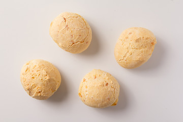Pao de Queijo is a cheese bread ball from Brazil. Also known as Chipa, Pandebono and Pan de Yuca. Snacks over white background, minimalism. - Powered by Adobe
