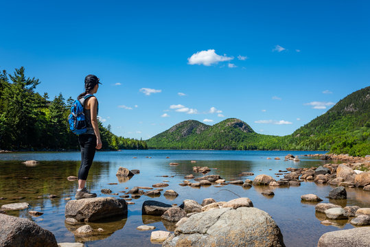 Hiker enjoying the view at Jordan Pond in Acadia National Park