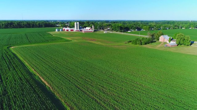 Country Road Through Idyllic Dairy Farms And Rural Homes, Aerial View.
