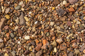 Sea stones on the beach of red sea background or texture.