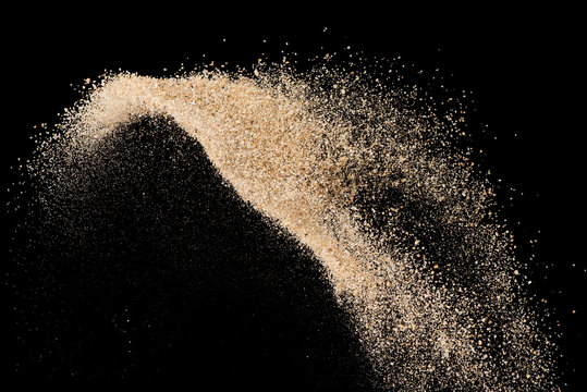 Sand flying explode on black background ,throwing freeze stop motion object design