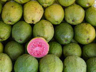 Green guava or pink guava showcase for sale at fair, fresh produce and rich in vitamin A.