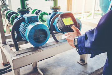 Technician thermography servicing an water Motor Cooling Tower in factory
