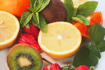 Fototapeta na wymiar citrus fruits and strawberries on white background
