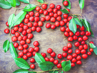 ripe cherries on a wooden background