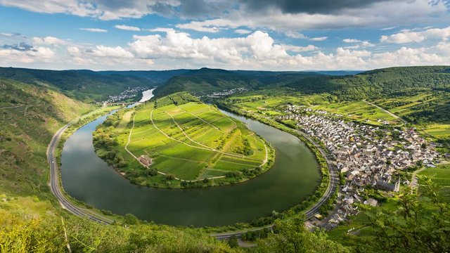 Timelapse sequence of a meander or riverbend of the Moselle River in the Eifel village of Bremm in Germany in summer. Seen from the Calmont vineyards in 4K resolution.