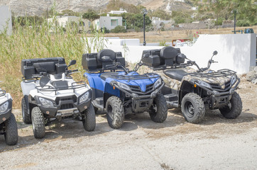Obraz na płótnie Canvas New colorful ATVs for rent , Santorini