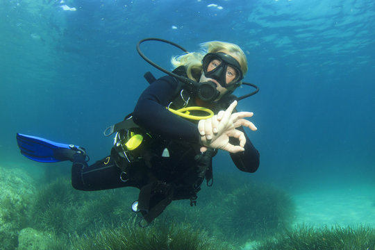 Female scuba diver okay signal    
