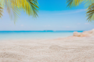 White sand on the beach with blurred sea and coconut tree background - can used for display or montage your products.