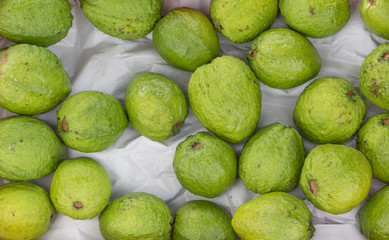 Green guava or pink guava showcase for sale at fair, fresh produce and rich in vitamin A.