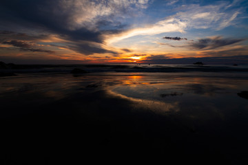 Fototapeta na wymiar Silhouette at sunset by the sea and light orange.