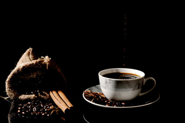 Hot black coffee cup on a black background.