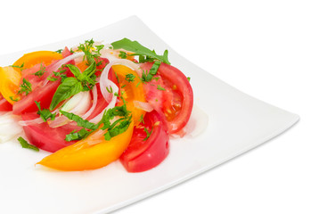 Salad of red and yellow tomatoes and onion close-up