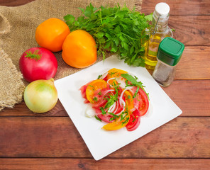 Salad of red and yellow tomatoes and ingredients for preparation