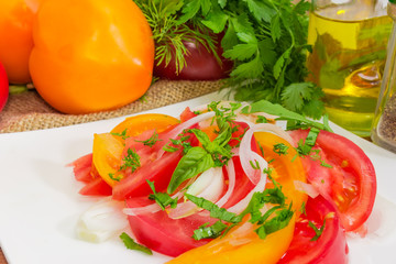 Salad of red and yellow tomatoes closeup at selective focus
