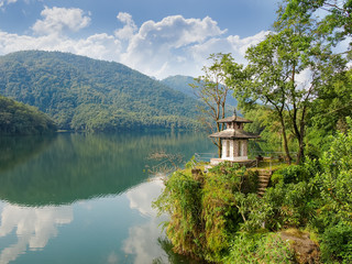 Fototapeta na wymiar Phewa Lake in Pokhara with Buddhist chapel on coast, Nepal