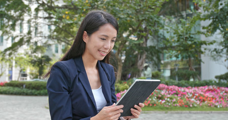 Fototapeta premium Young Businesswoman use of digital tablet computer at outdoor