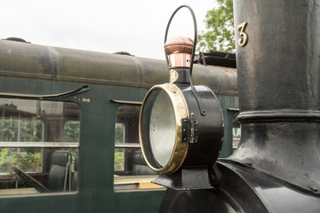 old steam train with a large oil lamp