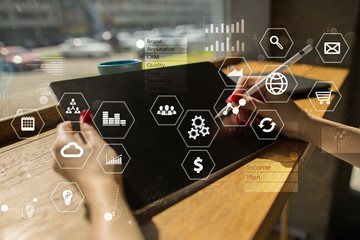 Business and technology concept. Graphs and icons on virtual screen background.