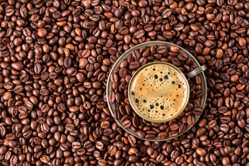 Cup of coffee with fresh roasted coffee beans