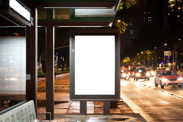 Blank white mockup in bus stop at night