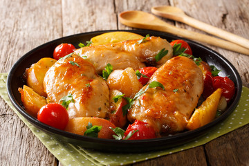 Summer food: chicken breast baked with fresh peaches, tomatoes, onions and honey garlic sauce close-up on a plate. horizontal © FomaA
