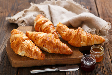fresh croissants on a wooden board
