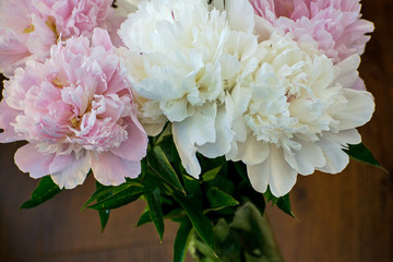 Elegant bouquet of white and pink peonies in a vase. Delicate white and pink peonies.