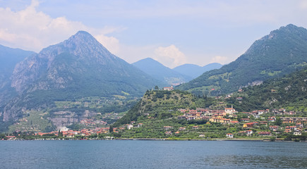Fototapeta na wymiar Iseo lake view, outdoor panorama on beautiful scenery, green hills and forests, sunny day, Lombardy, Italy