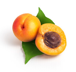 Fresh yellow apricots with green leaf on a white background